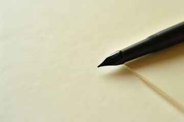 Close-Up of Black Fountain Pen on Cream Paper
