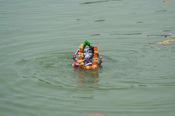 Vadodara, Gujarat / India - September 15, 2016 : A man dissolving the statue of the Lord Shree...