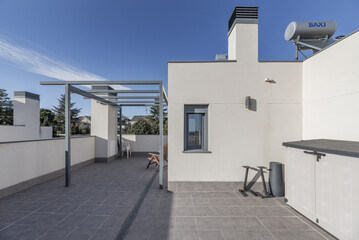 Attic floor of a single-family home with clear floors, a canopy without an awning and gray...