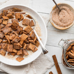 A bowl of homemade low carb cinnamon toast crispy cereal served with fresh milk.