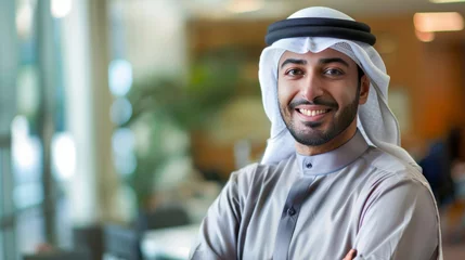  Happy Emirati Arab at office wearing Kandura looking at front ideal for Middle East business concept © Sasint