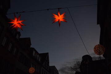 Star shaped Christmas lights above a street