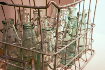 Vintage milk glass bottle in metal wire box of Soviet times