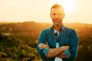 Portrait of adult man during summer sunset in countryside