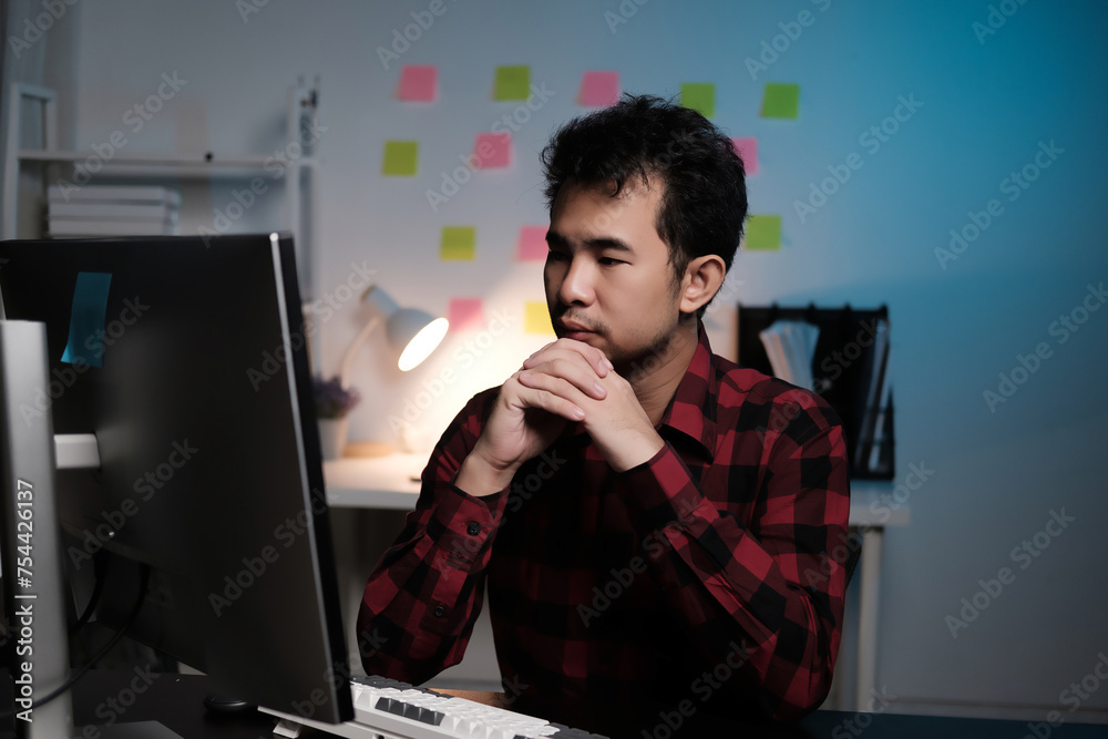 Aufkleber A man is sitting at a desk with a computer monitor in front of him