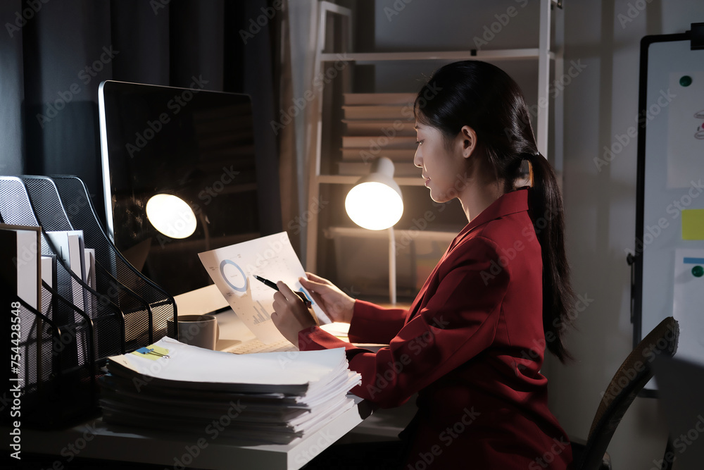 Poster a woman in a red jacket is sitting at a desk with a computer monitor