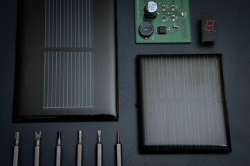 
A range of different electronic components and devices with dark tones, showcasing different technologies and circuits and solar renewable energy.