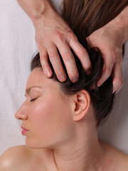 Beautiful Woman enjoying head and scalp massage. Skin and Body care. Beauty treatment.