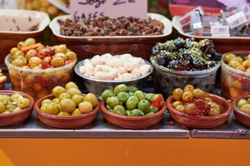Pickled green olives at a market to taste