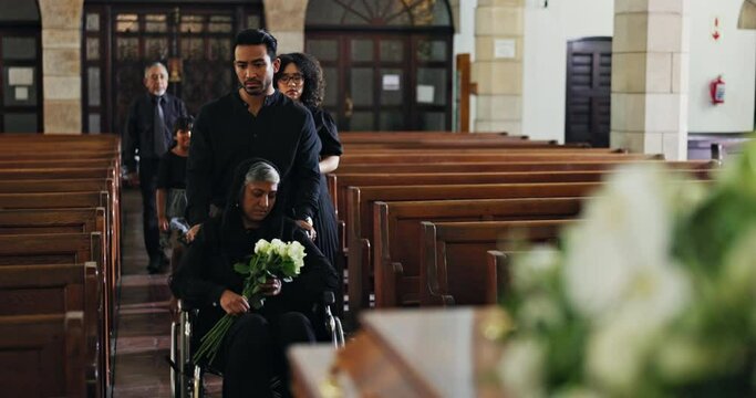 Grief, family and old woman in wheelchair at funeral together for memorial service at church for respect, support and comfort. Death, chapel and men and widow with memory, loss and spiritual farewell