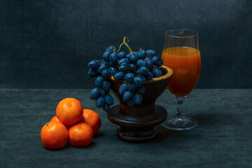 Still life with tangerines, grapes and orange juice