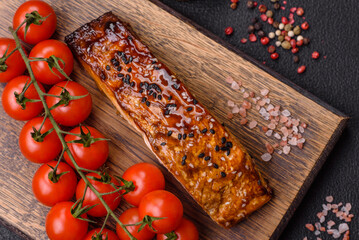 Delicious red salmon fish grilled with sauce and sesame, spices and herbs