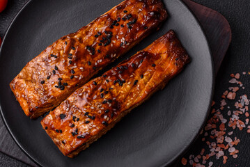 Delicious red salmon fish grilled with sauce and sesame, spices and herbs