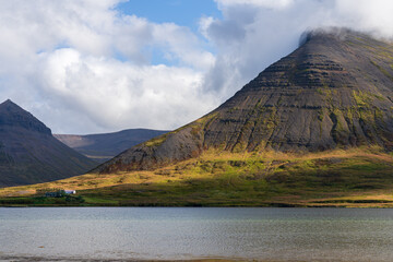 Bay at Önundarfjörður fjord in Westfjords, Iceland. Scenic view of majestic mountain and small building 