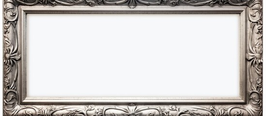 An ornate silver frame, suitable for paintings, mirrors, or photos, is displayed against a clean white background. The intricate details of the frame enhance its elegance and sophistication.