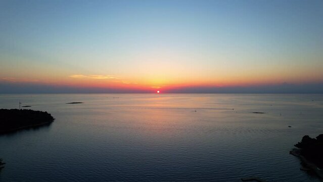 Porec - Croatia - Aerial view of the sunset falling on the water.