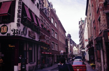 Street scenes near the Manneken Pis in Brussels, with hotels, restaurant, residential areas, narrow street and Church of Notre-Dame de Bon Secours during 1990s
