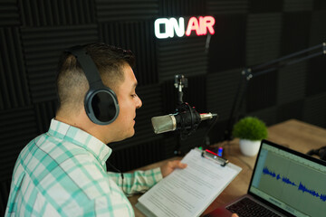 Radio host with headphones in the recording studio for a podcast