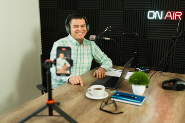 Excited podcast host live streaming while recording an episode
