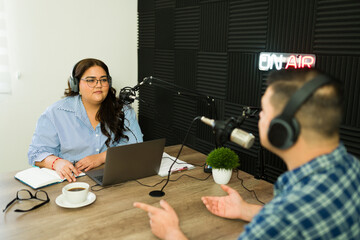 Hispanic radio host interviewing a guest for her talk show podcast