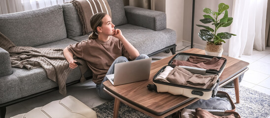 Obraz premium Travel,woman packing luggage in suitcase and planning solo trip eco friendly,travel banner and packing suitcase.