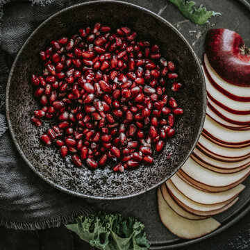 Closeup of fresh pomegranate with sliced apple