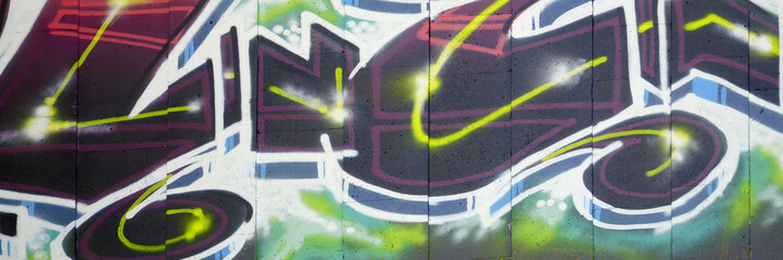 Colorful background of graffiti painting artwork with bright aerosol outlines on wall. Old school street art piece made with aerosol spray paint cans. Contemporary youth culture backdrop