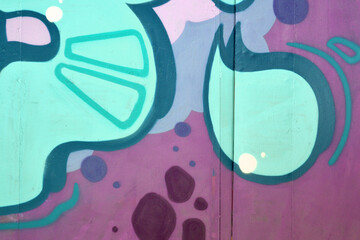Colorful background of graffiti painting artwork with bright aerosol outlines on wall. Old school...