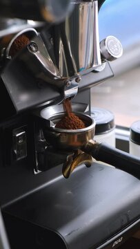 The barista makes coffee, grinds coffee in a coffee grinder, pours espresso, whips milk with a steamer, pours cappuccino and latte with a heart. The coffee machine is making an espresso. Failure
