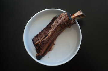 Beef rib on white plate