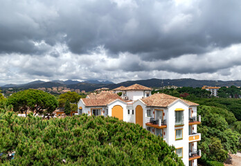 Fototapeta na wymiar Rain clouds on the Pyrenees mountains and a beautiful landscape with blooming pine trees in Elviria, Marbella. Spain