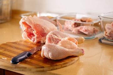 Preparing a chicken to cut and store in containers.