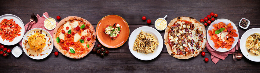 Delicious Italian food table scene. Collection of pizzas, pastas, gnocchi, risotto and bruschetta. Above view on a dark wood banner background. - 754469336
