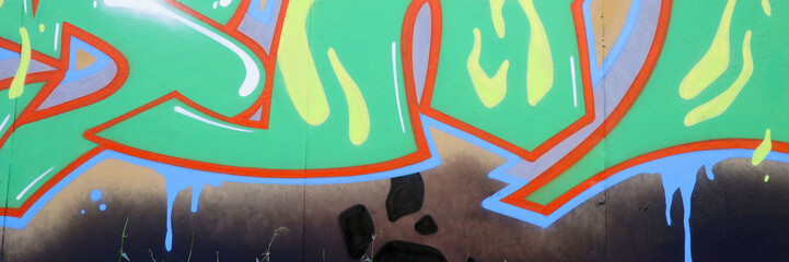 Colorful background of graffiti painting artwork with bright aerosol outlines on wall. Old school...