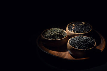 Tea leaves in wooden bowls shot in low key