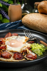 Fried egg and sliced sausage.