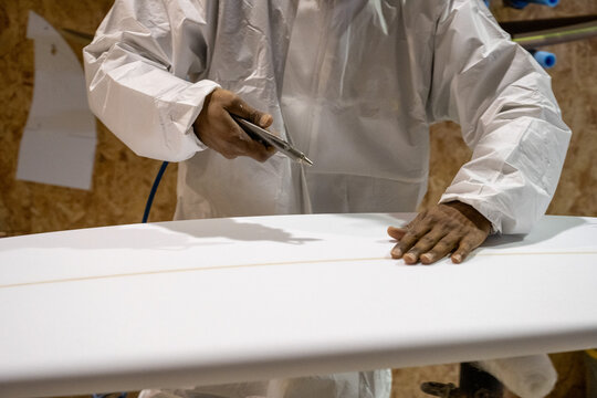 Shaper working on surf board