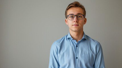 Head shot portrait of young business man posing on grey wall studio background - 754488125