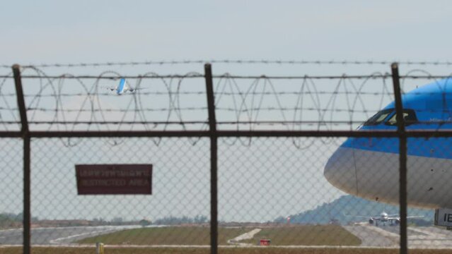 PHUKET, THAILAND - FEBRUARY 10, 2023: Boeing 787-8 Dreamliner, G-TUIE of TUI Airways taxiing to the runway at Phuket Airport. Airplane behind the fence of the airport, side view medium shot