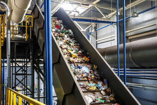 moving conveyor transporter on Modern waste recycling processing plant. Separate and sorting garbage collection. Recycling and storage of waste for further disposal.