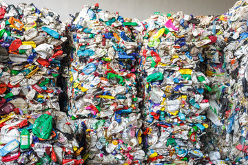 Plastic pressed bales at the modern waste hazardous processing plant. Separate garbage collection. Recycling and storage of waste for further disposal. Business for sorting and processing of waste.