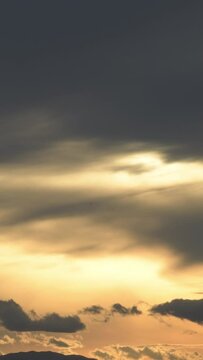 Sky with clouds at sunset. 4K Vertical