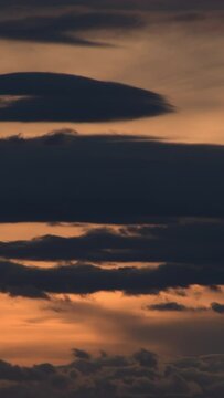 Clouds moving in the sky at sunset. 4K Vertical