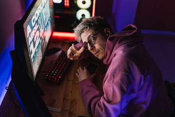 Graphic designer with glasses working for an event poster in his room