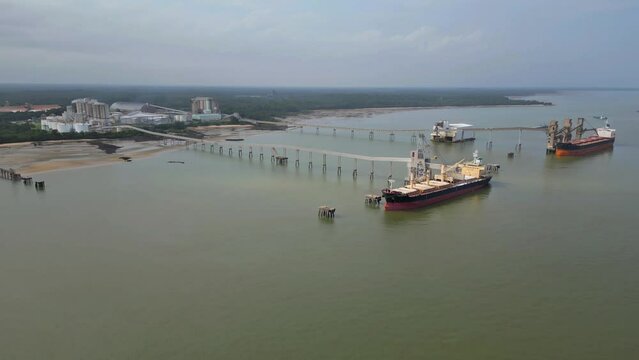 Aerial drone view of the private port in Barcarena, Para state, BR, of an industry that processes kaolin and ships globally.