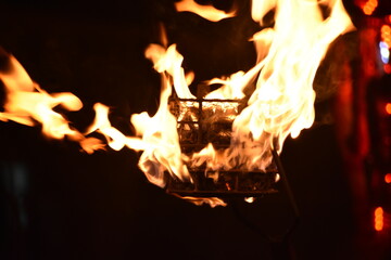 Naklejka premium Flames of a coppara torch that lighting in Kandy Esala Perahera at Temple of the Tooth (Sri Dalada Maligawa), Kandy, Sri Lanka.