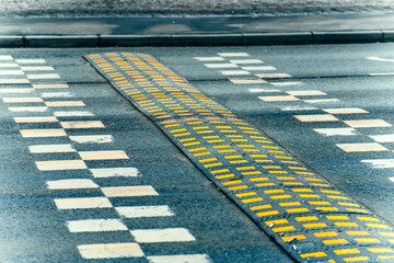 Long and wide speed bump on the road with markings