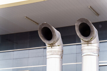 Two curved metal ventilation pipes