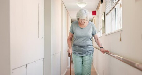Stick, walking and old woman with a disability in recover or rehabilitation in a clinic for mobility. Healthcare, medical and physiotherapy with a rail elderly female patient alone in a nursing home
