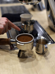 waiter preparing a coffee with his barista utensils